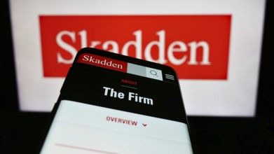 Stuttgart, Germany, 12-17-2023: Mobile phone with website of US law firm Skadden, Arps, Slate,