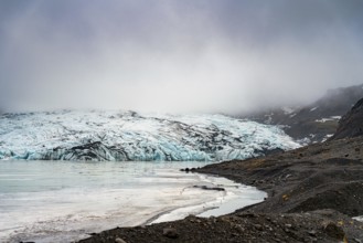 Misty atmosphere enveloping a glacier as it meets the rocky shoreline, iceberg Iceland, glacier,