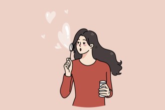 Happy young woman blow soap bubbles with heart shape. Kind girl share spread love and care. Concept