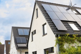 Solar panels and solar thermal energy on the roof of a detached house in Essen, Germany, Europe