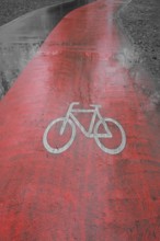 Red coloured stripe for cyclists, to the side of it all grey. Ulm, Baden-Wuerttemberg, Germany,
