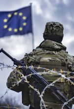 Symbolic image for the threat of war in the EU, a soldier in full combat gear stands in front of an