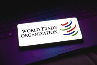 In this photo illustration, the World Trade Organization (WTO) logo is displayed on a smartphone