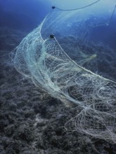 A fishing net underwater fixed on the seabed, deep water