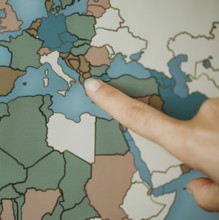 Person pointing europe map