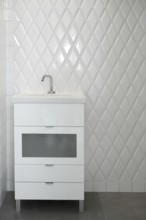 Toilet sink in a white room diamond shape tiles modern vintage bathroom
