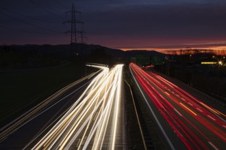 Long exposure of an illuminated motorway at night with disappearing light traces of vehicles,