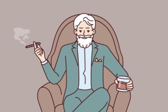 Elderly man aristocrat sits in armchair in expensive formal suit and drinks brandy with cigar.
