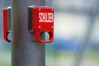 Emergency brake with the german word Schulden for Debts