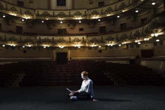 Mime reading manuscript stage empty auditorium. High resolution photo