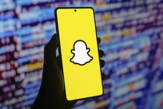 In this photo illustration, the Snapchat logo is displayed on a smartphone screen