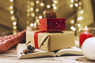 present boxes book near burning candle . Resolution and high quality beautiful photo