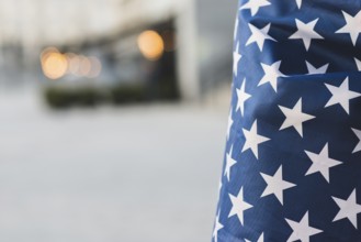 Crop american flag with wrapped person