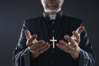 Priest open hands arms praying offering oblation