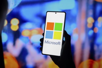 In this photo illustration, the Microsoft Corporation logo is displayed on a smartphone screen