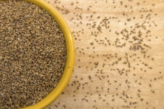 Top View of Ajwain, Carom Seeds, Thymol Seeds, Bishop's Weed in a Yellow Bowl, Closeup