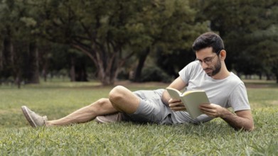 Young man reading interesting book