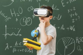 Side view boy wearing virtual reality headset holding books