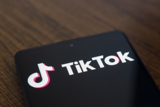 In this photo illustration, the TikTok logo is displayed on a smartphone screen