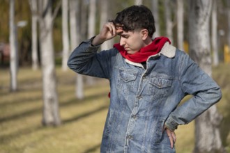 Stressed and tired young man touches his head because of a headache