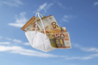 Medical ffp2 face mask against covid-19 filled like a bag with euro banknotes, concept for