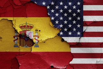 Flags of Spain and USA painted on cracked wall