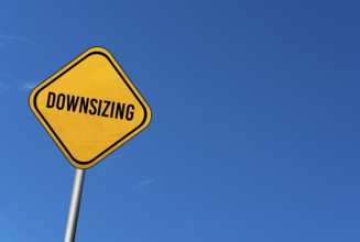 Downsizing, yellow sign with blue sky