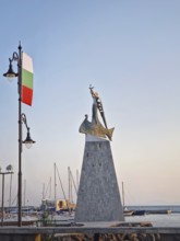 The statue of Saint Nicholas patron of sailors in the old town of Nessebar, Bulgaria. Serene sunset