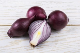 Red onion bulb cut in half on a certain background