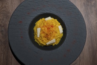 Elegant Plate with Risotto alla Milanese with Saffron and Parmesan Cheese in Lugano, Ticino,