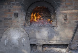 Firing up a traditional bread oven, Münsterland, North Rhine-Westphalia, Germany, Europe