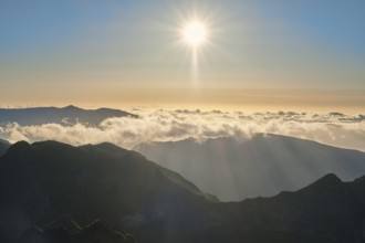 Aerial drone view of mountains over clouds near Pico Ruivo on sunset. Madeira island, Portugal,