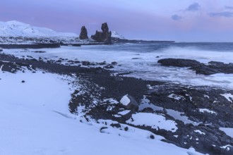 Rocks and surf on the coast, evening light, sun, snow, winter, Arnarstapi, Snaefellsnes,