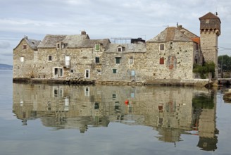 Old fortification from the Mediterranean reflected in the water, town of Kastela, Split, Dalmatia,