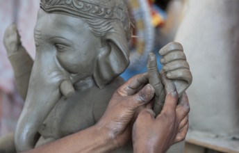 Artisan work on idols of the elephant-headed Hindu deity Ganesha at a workshop ahead of the Ganesh