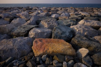 Stones, rocks that form the foundation for the artificial palm island, The Boardwalk, waterfront