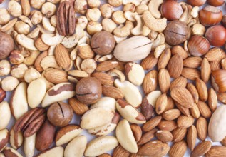 Background and texture made from different kinds of nuts. hazelnut, brazil nut, almond, pumpkin
