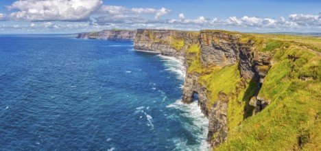 Breathtaking coastal view with green cliffs and deep blue sea under a bright sky, Cliffs of Moher