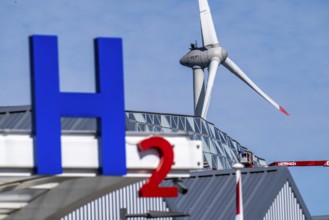 Hydrogen filling station in Antwerp, for cars and lorries, H2 lettering, wind turbine in the
