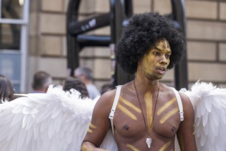 Street performers with angel wings, world's largest cultural festival The Fringe, High Street,