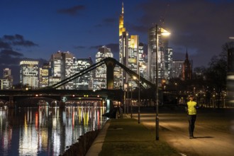 Skyline of the city centre of Frankfurt am Main, joggers on the pavement, promenade along the river