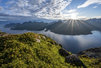 View of Fjord Raftsund and mountains in the evening light, sun star, view from the top of