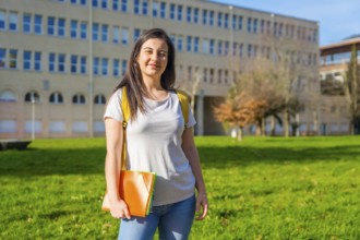 Portrait of a caucasian cheerful student outside the university college