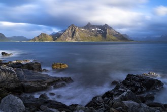 Landscape with sea and mountains on the Lofoten Islands, view across the fjord to the small town of