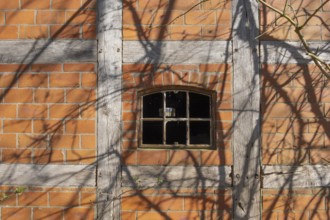 An old rusty window frame of a half-timbered barn, Wildeshauser Geest, Bassum, Diepholz, Lower