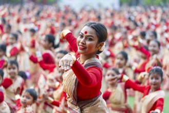 An instructor dance as participants follows the dance step in a Bihu dance workshop ahead of