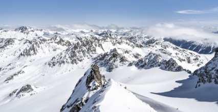 Mountain ridge of Piz Kesch, ascent on Piz Kesch or Piz d'Es-cha in winter, spectacular mountain