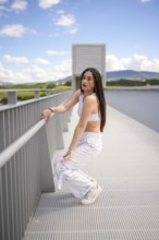 Vertical full lengt photo of a young caucasian beauty woman kneeling dancing modern urban music