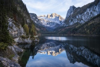 The Vordere Gosausee lake in autumn with a view of the Dachstein mountain range. The Gosaukamm on