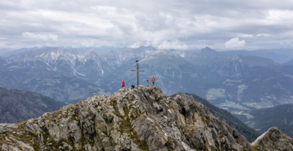 Aerial view, hiker on the Raudenspitze with summit cross, Carnic High Trail, Carnic Main Ridge,